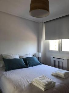 a bedroom with a bed with two towels on it at A Estrenar. Apartamento Reformado con vistas. in Salinas