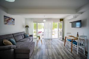 a living room with a couch and a table at Apartments Edera in Tivat