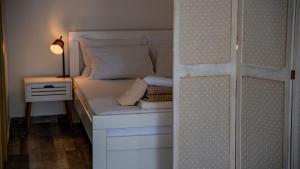a small bedroom with a bed and a night stand at Apartments Edera in Tivat