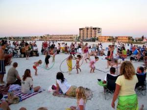 a crowd of people playing in the sand at the beach at Waterfront Boat Lift Bungalow in St Pete Beach