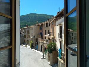 a view from a window of a city street at Villa des Lucioles in Annot