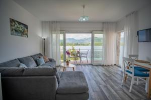 a living room with a couch and a table with a view at Apartments Edera in Tivat