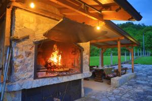 a large stone oven with a fire in it at Apartman Enjoy in Bihać
