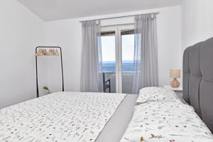 une chambre avec un lit avec vue sur l'océan dans l'établissement Sunny room, à Tučepi