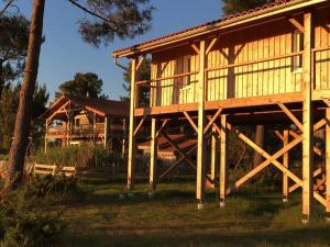 a large wooden house in front of a house at La Maison de l'Aérogrange in Biscarrosse