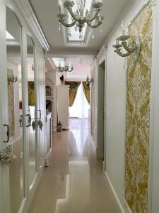a hallway of a home with a chandelier at Lux apartament in Focşani