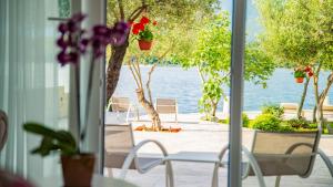 a porch with chairs and a view of the water at Apartments Edera in Tivat