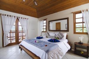 a bedroom with a large bed with a large mirror at Antigua Yacht Club Marina Resort in English Harbour Town