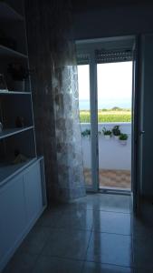 a room with a door open to a patio with a view at Bed&breakfast Albysuite in Termoli