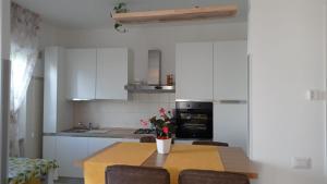 una cucina con tavolo, sedie e piano cottura di Bed&breakfast Albysuite a Termoli