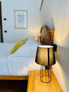 a lamp on a table next to a bed at Mulino del Casale - nature b&b in San Paolo Solbrito