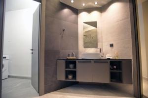 a bathroom with a sink and a mirror at Animus Premium apt in Nafplio