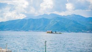 a small island in the middle of a large body of water at Apartments Edera in Tivat