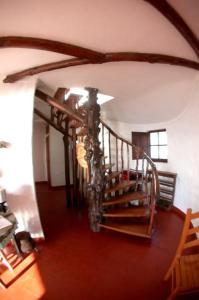 a hallway with a spiral staircase in a house at CASA DAS PONTES in Ribamar