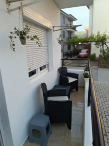 a balcony with chairs and a window on a building at Finesi apartments 3 in Ohrid