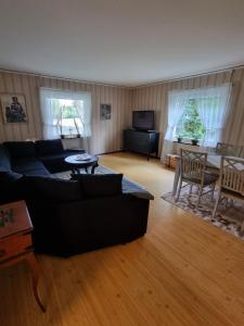 a living room with a couch and a table at Gamla Kooperativa in Ekshärad