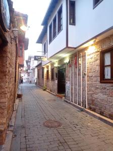 an empty street with a building and a cobblestone road at Grand Erken Hotel in Antalya