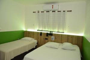 Ένα ή περισσότερα κρεβάτια σε δωμάτιο στο HOTEL VITORIA REGIA