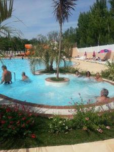 a group of people in a swimming pool at Mobil home 6/8personnes in Sérignan