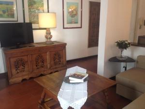 a living room with a table and a tv at Domus Antonella a Trastevere in Rome