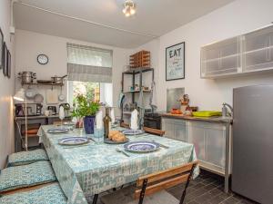 a kitchen with a table with a table cloth on it at Headland Cottages in Coverack