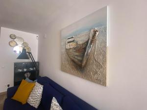 a painting of a boat hanging on a wall at Nice Holiday Home - Sol Espanol in Sitio de Calahonda
