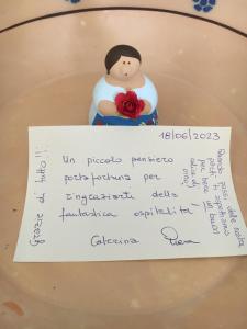 a piece of paper with a man holding a flower at La Racioppola in Ostuni