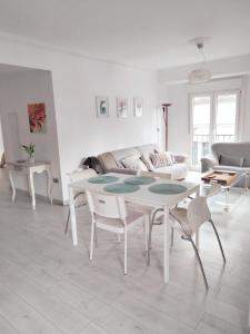 a living room with a table and a couch at EL RINCON DE LUZ 2 in Padrón