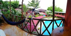 a hammock in a room next to a pool at Madera Labrada Lodge Ecologico in Tarapoto