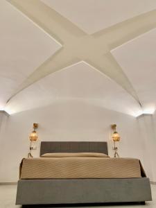 a bedroom with a large bed in a white room at Il Palazzotto in Fasano