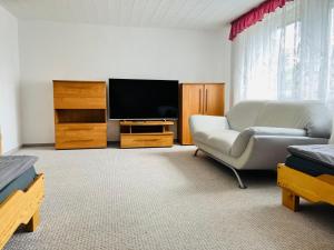 a living room with a couch and a flat screen tv at Ferienhaus Kyritz Gantikow in Mechow