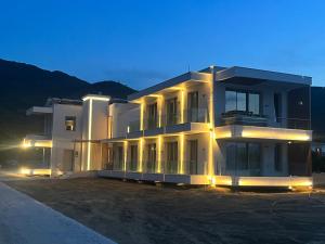 a large white building with lights on it at night at Balance Accommodation in Stavros