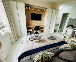 a bedroom with a large bed with pillows on it at Travellar Spot 912 in Ribeirão Preto