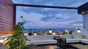 a patio with white furniture and a view of the ocean at Adriatic Apartments in Ulcinj