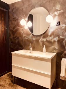 a bathroom with a white sink and a mirror at VILLA LA DUQUESA 