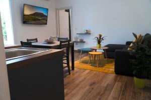 a kitchen and living room with a sink and a couch at Alessandra's apartment in Sassari +10 photos