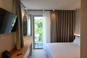 a hotel room with a bed and a sliding glass door at Balance Accommodation in Stavros