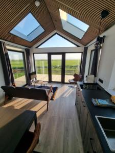 a kitchen with skylights and a living room at Arctic Exclusive Ranch in Kirkjubæjarklaustur