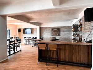a bar in a restaurant with bar stools at Hotel Santa María in Taxco de Alarcón