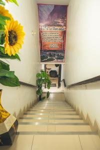 a stairway with a sunflower and a poster on the wall at Hostal La Morada in Chachapoyas