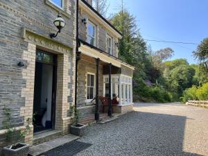 a brick building with a door on a street at The Crag in Wadebridge