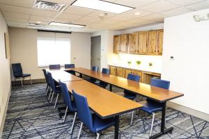 a conference room with wooden tables and blue chairs at Holiday Inn Express & Suites Donegal, an IHG Hotel in Donegal