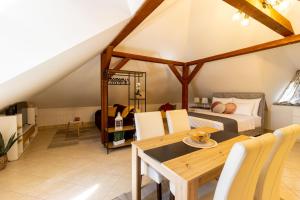 a bedroom with a bed and a wooden table at STYLISH STUDIO APARTMENT BURE in Murter
