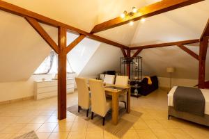 a room with a table and chairs and a bed at STYLISH STUDIO APARTMENT BURE in Murter