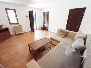 a living room with a couch and a table at Private House with Garden in Mislea
