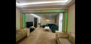 a living room with a couch and a television at Tanger cente ville in Tangier