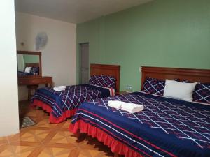 Postel nebo postele na pokoji v ubytování Hotel John & Rose
