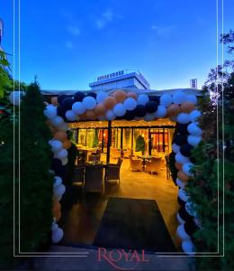 a balloon arch with a table in front of a building at Hotel Royal in Prishtinë