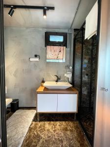 a bathroom with a sink and a shower at Butiq Garden in Kemer