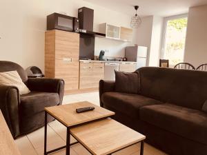 a living room with a couch and a table at Sur le chemin de la plage in Cherbourg en Cotentin